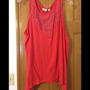 Coral tank top with design on the front.